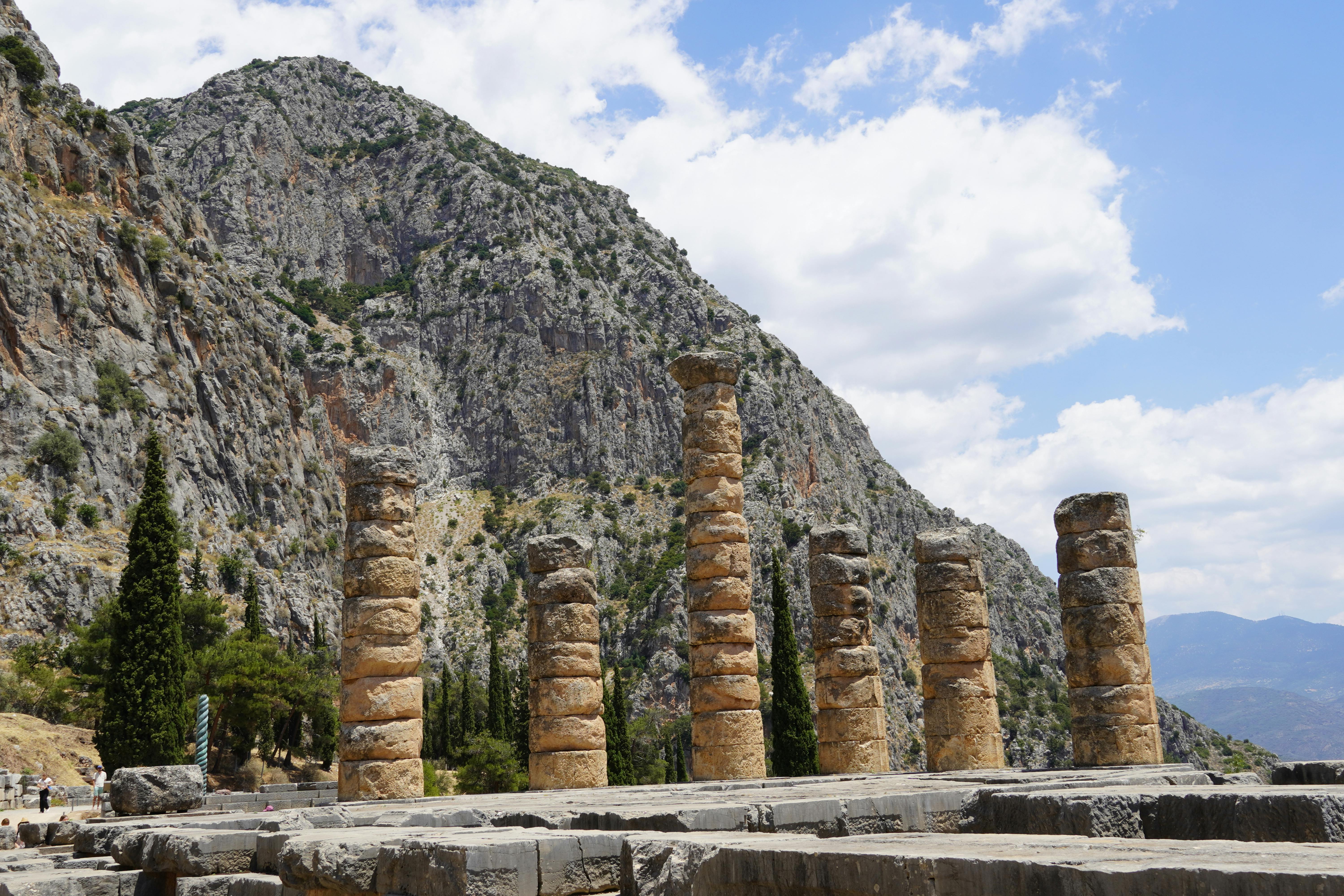 Capture of ancient temple columns at Delphi, Greece, under a bright sky.